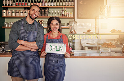 Buy stock photo Cafe, portrait or happy couple with an open sign to welcome sales with hospitality at a coffee shop. Manager, partnership or entrepreneurs smile standing with an opening or advertising board in store