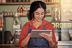 Small business, cafe barista and woman with tablet to manage orders, inventory and stock check. Coffee shop waiter, technology and happy young female waitress with touchscreen for managing sales.