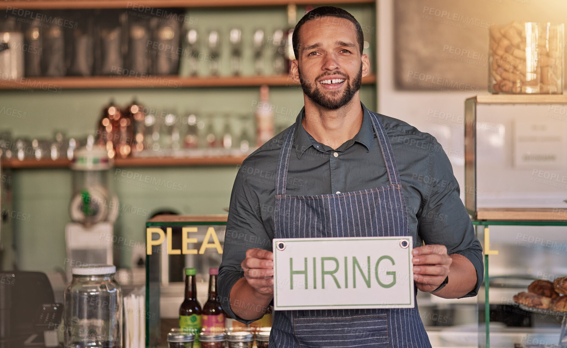 Buy stock photo Small business, man or business owner with a hiring sign for job vacancy offer in cafe or coffee shop. Boss, marketing or happy entrepreneur smiles with an onborading recruitment message in store
