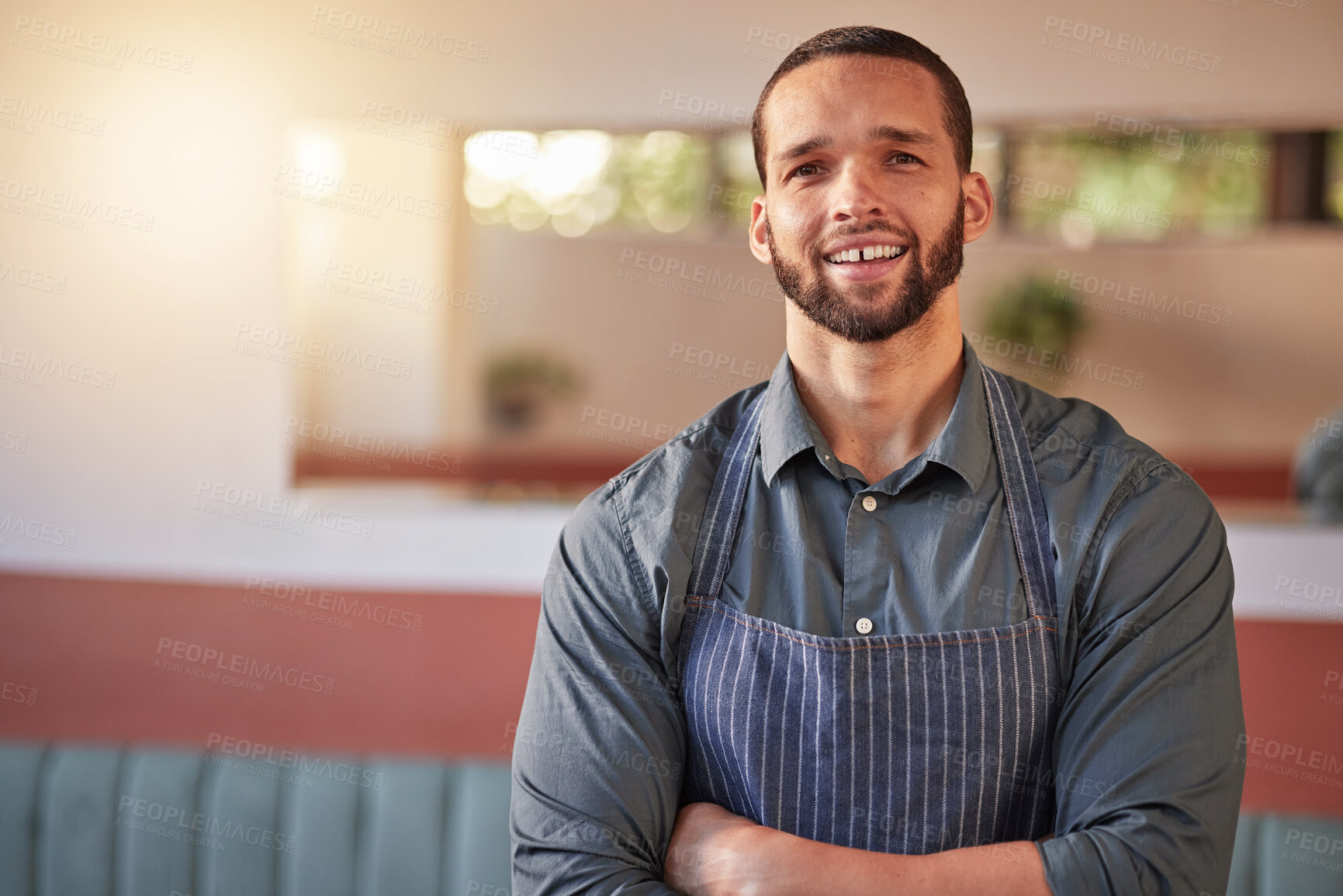 Buy stock photo Restaurant, waiter portrait and man with arms crossed ready to take your order. Small business, server and confident, happy and proud young male employee from Brazil, worker or startup business owner