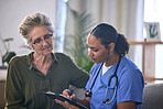 Medical, retirement and clipboard with a nurse and woman in consultation over treatment in a home. Healthcare, insurance and documents with a female medicine professional taking to a mature patient