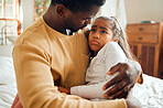 Sick, sad and father holding his child with an illness, pain or problem in her bedroom at their home. Ill, care and African dad holding his girl kid with concern while she has the flu, cold or fever.