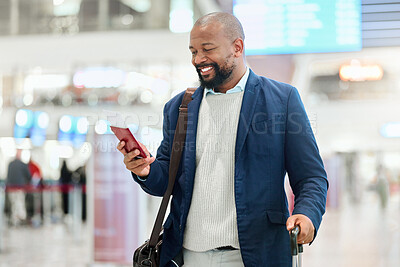 Buy stock photo Businessman, phone and smile with luggage for travel, journey or texting in communication at the airport. Happy black man, person or employee holding smartphone for chatting, traveling or work trip