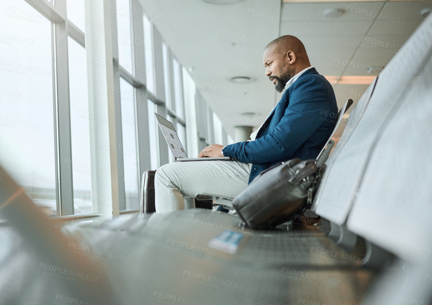 Buy stock photo Travel, vip and businessman on a laptop at an airport working and waiting at terminal or boarding lounge. Entrepreneur, corporate or professional using computer at airline hub about to go on a flight