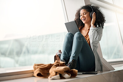 Buy stock photo Travel tablet, music headphones and black woman streaming radio or podcast. Technology, relax and happy female with touchscreen for social media app, networking and internet browsing at airport lobby