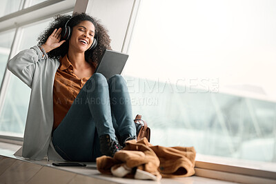 Buy stock photo Relax, travel or black woman on tablet and headphones for music, podcast or radio in airport lobby. Smile, mockup or happy girl on audio tech for communication, networking or social media network app