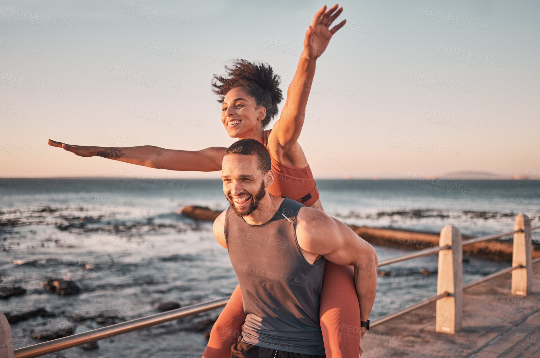 Buy stock photo Sunset, relax and couple piggyback by ocean enjoying holiday, vacation and quality time on weekend. Love, freedom and happy black man and woman after exercise, fitness workout and training by sea