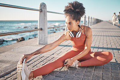 Buy stock photo Black woman, seaside and stretching for workout, training and exercise for wellness, energy and health. African American female, girl and athlete stretch legs, promenade and fitness for stress relief