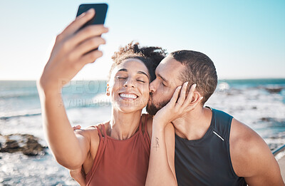 Buy stock photo Selfie kiss, gratitude and couple with a phone for streaming, training and love at the beach in Bali. Caring, exercise and affectionate man and woman with a smile for a mobile photo after a workout