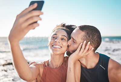 Buy stock photo Selfie kiss, love and couple with a phone for streaming, training and care at the beach in Bali. Gratitude, exercise and affectionate man and woman with a smile for a mobile photo after a workout