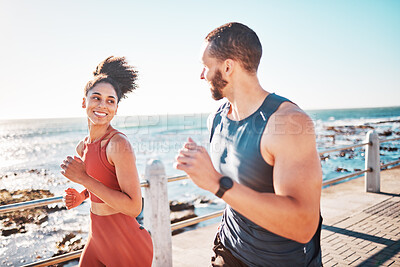 Buy stock photo Running, fitness and sea with a sports couple outdoor during summer for cardio or endurance exercise. Health, training and ocean with a man and woman runner on a promenade for a workout together