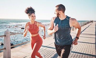 Buy stock photo Running, exercise and training with a sports couple outdoor in summer for a cardio or endurance workout. Health, fitness and ocean with a man and woman runner on a promenade for a challenge together