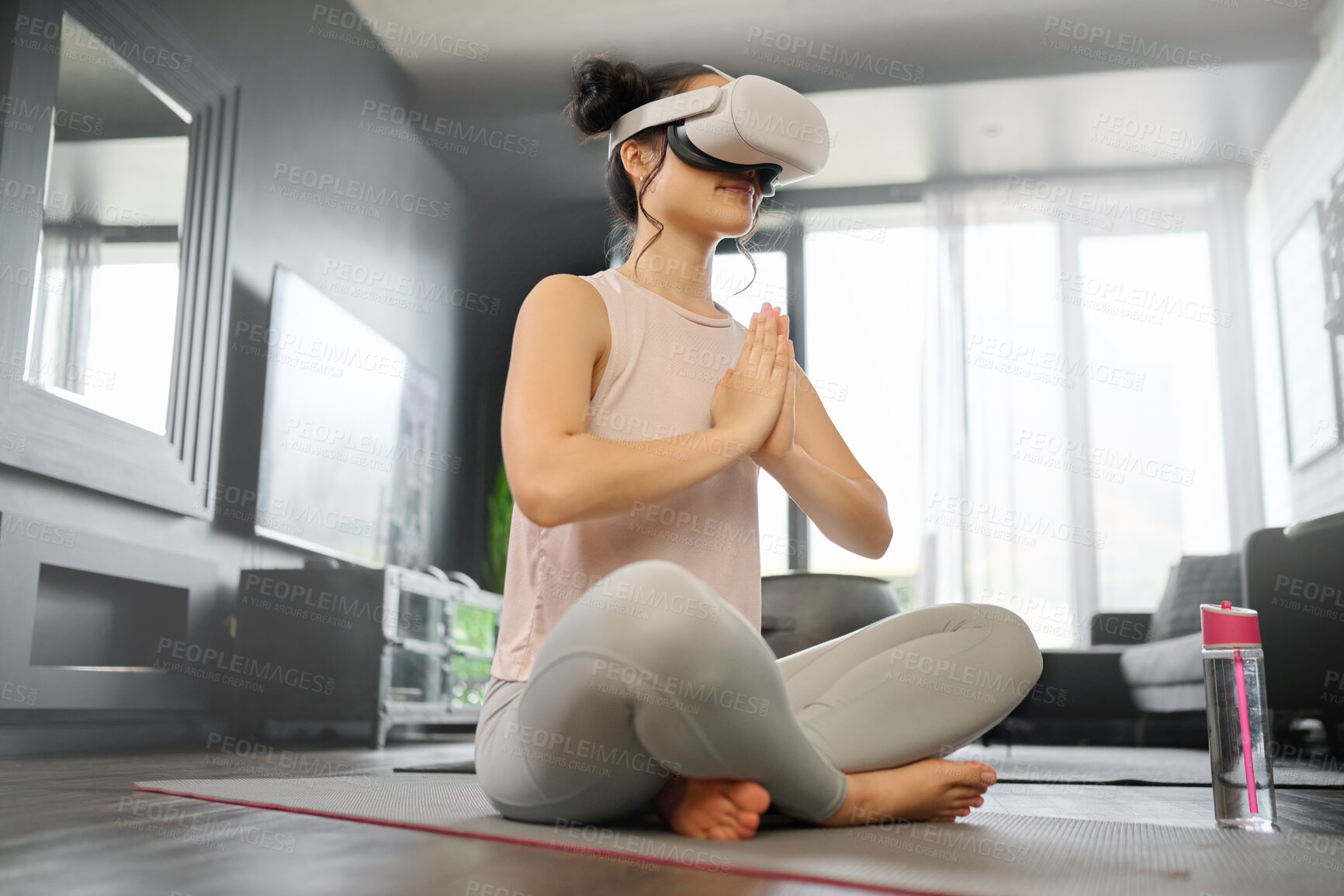 Buy stock photo VR, meditation and fitness with a woman using a headset to access the metaverse in her home for health. Virtual reality, yoga and exercise with a young female yogi meditating in her house using 3d ai