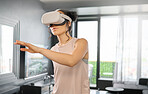 Virtual reality, metaverse and technology with a woman in the living room of her home using a headset to access a 3d game. Futuristic, VR and gaming with a female gamer using ai to access games