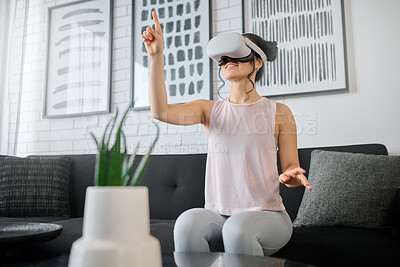 Buy stock photo Virtual reality, metaverse and gaming with a woman in the living room of her home using a headset to access a 3d game. Futuristic, vr and technology with a female gamer using ai to play online games