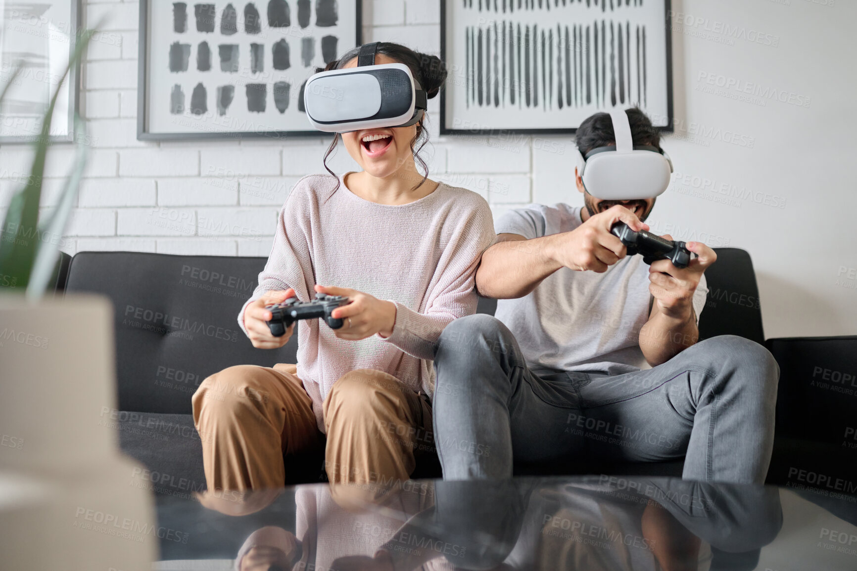 Buy stock photo VR, gaming and metaverse with a couple playing video games in their home together for fun or enjoyment. Virtual reality, game and 3d ai with a man and woman gamer bonding in a house living room