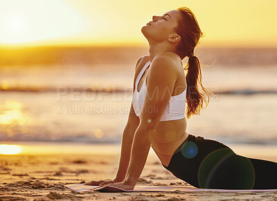 Buy stock photo Yoga, cobra stretching and woman at beach for fitness, health and wellness. Sunset, zen chakra and female yogi practicing pilates, meditation and training, stretch and exercise outdoors at seashore.