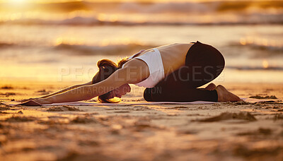 Buy stock photo Beach, yoga child pose and woman stretching for health, fitness and wellness. Sunset pilates, zen chakra and young female yogi exercise, workout or meditation training at seashore outdoors alone.