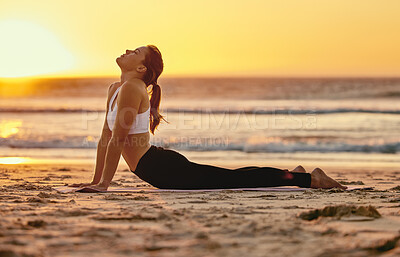 Buy stock photo Yoga, cobra stretch and woman at beach for fitness, health and wellness. Sunset, zen chakra and female yogi practicing pilates, meditation and training, stretching and exercise outdoors at seashore.
