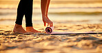 Beach, hands and woman roll yoga mat getting ready for workout, exercise or stretching. Zen, meditation and feet of female yogi outdoors on seashore while preparing for chakra training and pilates.