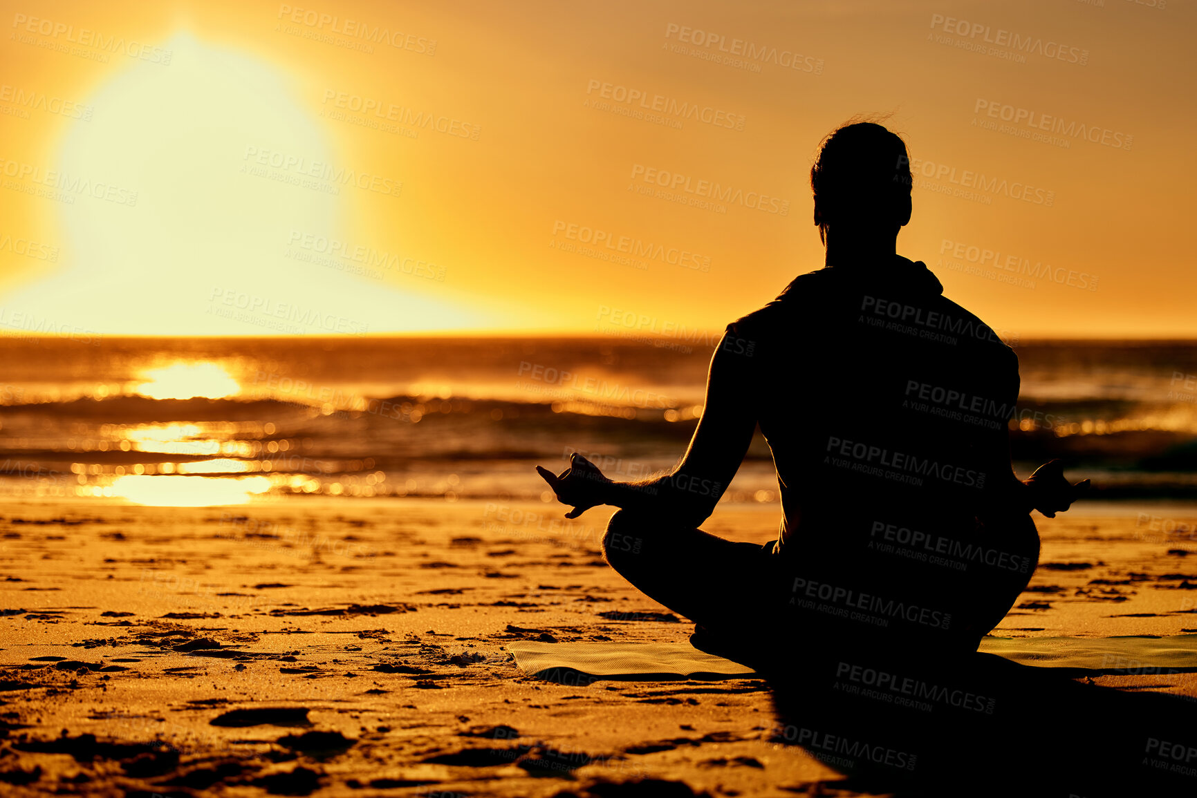 Buy stock photo Lotus, yoga and silhouette of man at beach outdoors for health and wellness. Sunset, zen meditation and shadow or outline of male yogi meditating, chakra training and mindfulness exercise at seashore