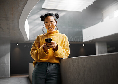 Buy stock photo Happy, woman and texting on phone in office building, relax while on internet, search and reading. Asian, girl and business entrepreneur with smartphone for research, office space or idea in Japan