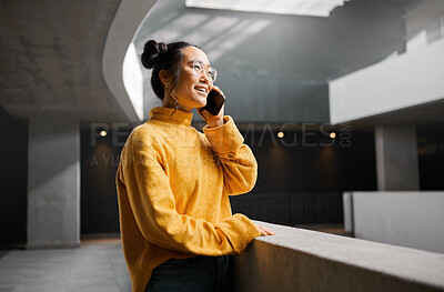 Buy stock photo Phone call, networking and mockup with an asian woman talking while standing in a hallway. Mobile, communication and conversation with an attractive young female speaking on her smartphone indoor