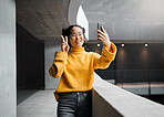 Woman, peace and selfie in office building, smile and happy while on internet, pose and emoji. Asian, girl and business entrepreneur with smartphone for photo, peace sign and hand for profile picture
