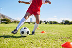 Soccer kid, field and training for sport fitness, balance and control with speed, strong body and development. Cropped football player child, fast dribbling and exercise feet on pitch in Cape Town