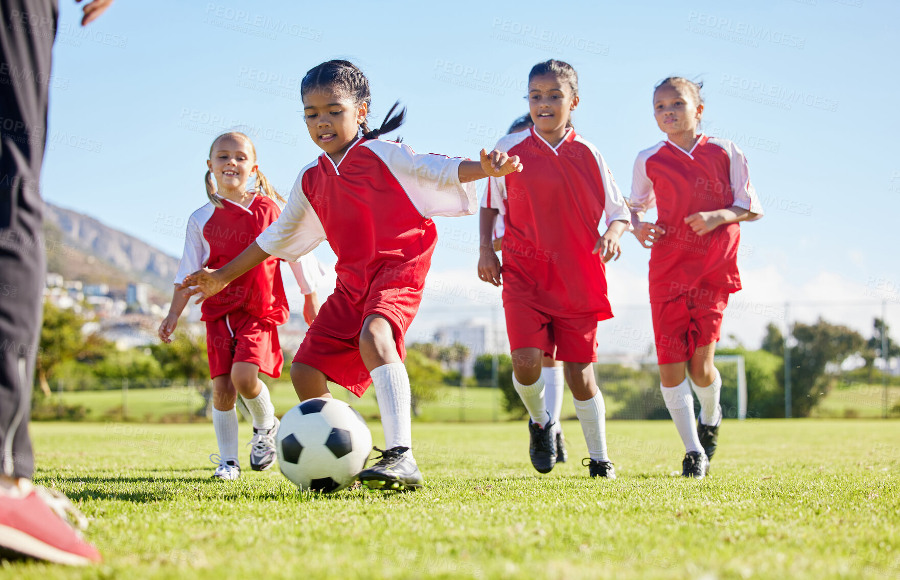 Buy stock photo Soccer, ball or sports and a girl team training or playing together on a field for practice. Fitness, football and grass with kids running or dribbling on a pitch for competition or exercise