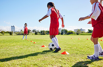 Buy stock photo Football, training or sports and a girl team playing with a ball together on a field for practice. Fitness, soccer and grass with kids running or dribbling on a pitch for competition or exercise