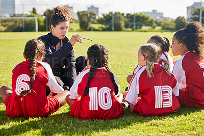 Buy stock photo Coaching, exercise or coach with children for soccer strategy, training and team goals in Canada. Team building, teamwork and woman planning group of girl on football field for game, match or workout