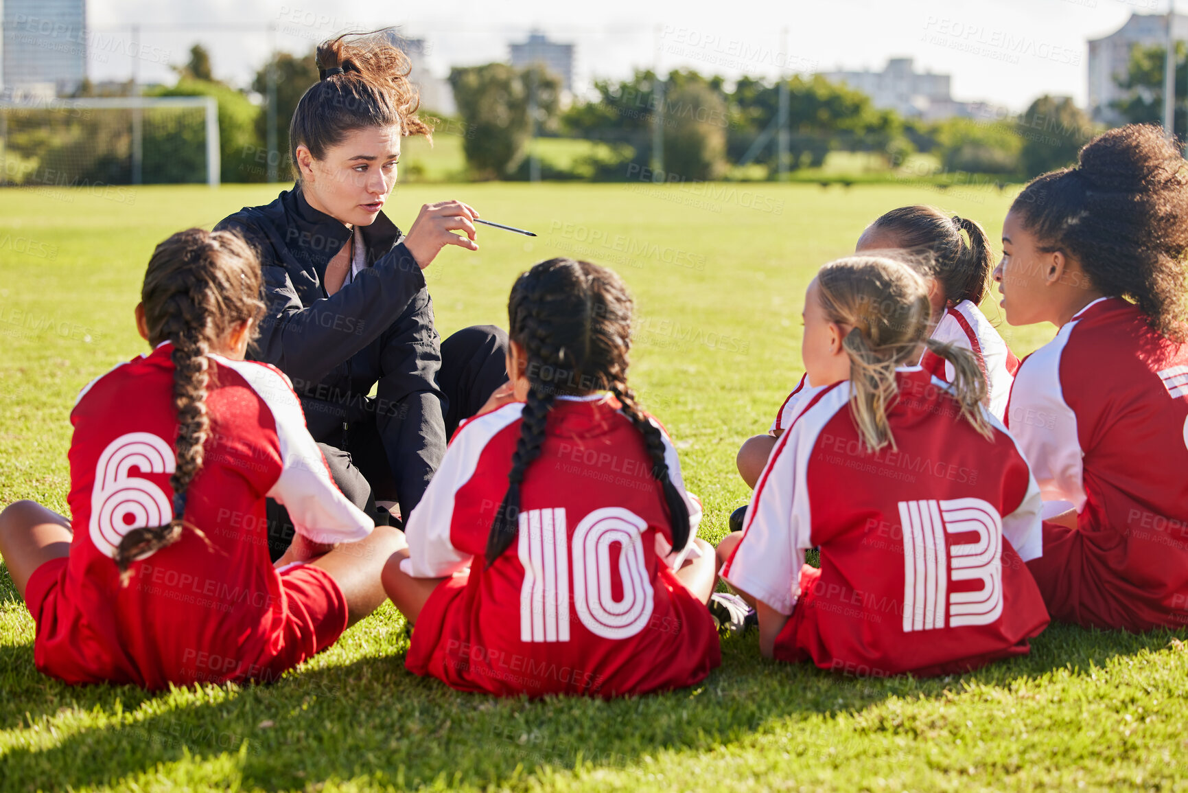 Buy stock photo Coaching, exercise or coach with children for soccer strategy, training and team goals in Canada. Team building, teamwork and woman planning group of girl on football field for game, match or workout