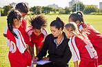 Planning, sports or coach with children for soccer strategy, training and team goals in Canada. team building, teamwork and woman coaching group of girls on football field for game, match or workout
