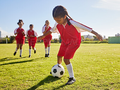 Buy stock photo Soccer, training or sports and a girl team playing with a ball together on a field for practice. Fitness, football and grass with kids running or dribblinf on a pitch for competition or exercise