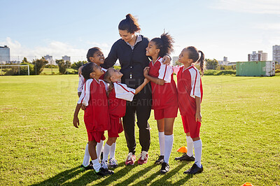 Buy stock photo Girl, soccer group and field with coach, team building hug and solidarity at sport training. Female kids, sports diversity and happy with friends, teamwork and football coaching with mentor woman