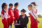 Planning, sports and coach with children for soccer strategy, training and team goals in England. Plan, teamwork and woman coaching a group of girls on football for a game, match or competition