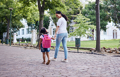 Buy stock photo Kindergarten, student and mother with daughter walking to school, relax and bonding while holding hands. First day, elementary and girl with mama on commute, morning travel, talking and sweet