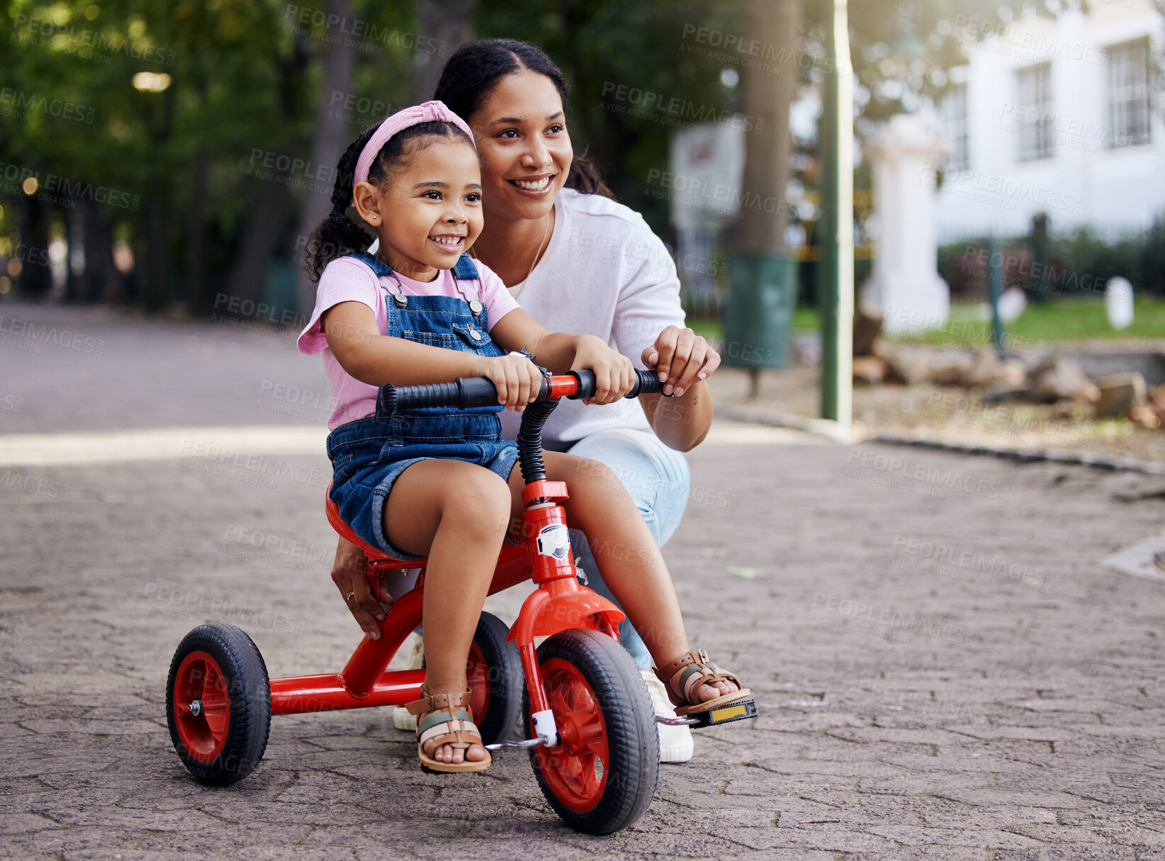 Buy stock photo Mother, little girl and bicycle teaching with training wheels for learning or practice at the park. Happy mom helping child to ride her first bike with smile for proud playful moments in the outdoors