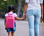 Holding hands, mom and child walking to school, help and care with support outdoor, education for knowledge and growth. Development in childhood, backpack and family, woman with girl and back view