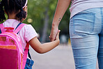 Holding hands, mother and child walking to school, help and care with support outdoor, education for knowledge and growth. Development in childhood, backpack and family, woman with girl and back view