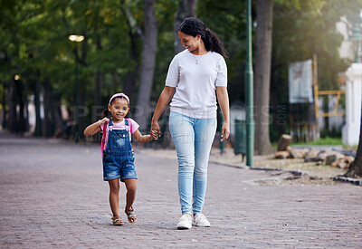 Buy stock photo Walking, park and mother holding hands with girl on journey for back to school, learning and class for first day. Love, black family and mom with child walk to kindergarten for education development