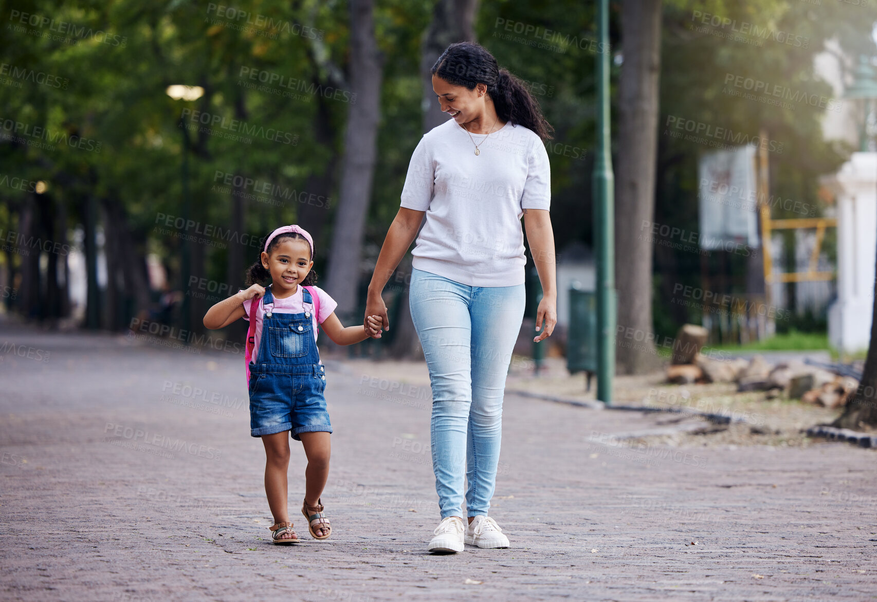 Buy stock photo Walking, park and mother holding hands with girl on journey for back to school, learning and class for first day. Love, black family and mom with child walk to kindergarten for education development