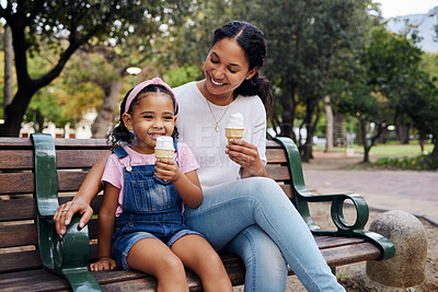 Buy stock photo Black family, park and ice cream with a mother and daughter bonding together while sitting on a bench outdoor in nature. Summer, children and garden with a woman and girl enjoying a sweet snack