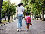 Mother, child and walking with backpack holding hands to school for safety at the outdoor park. Mom with little girl or daughter having a walk together for safe travel, trip or care for childhood