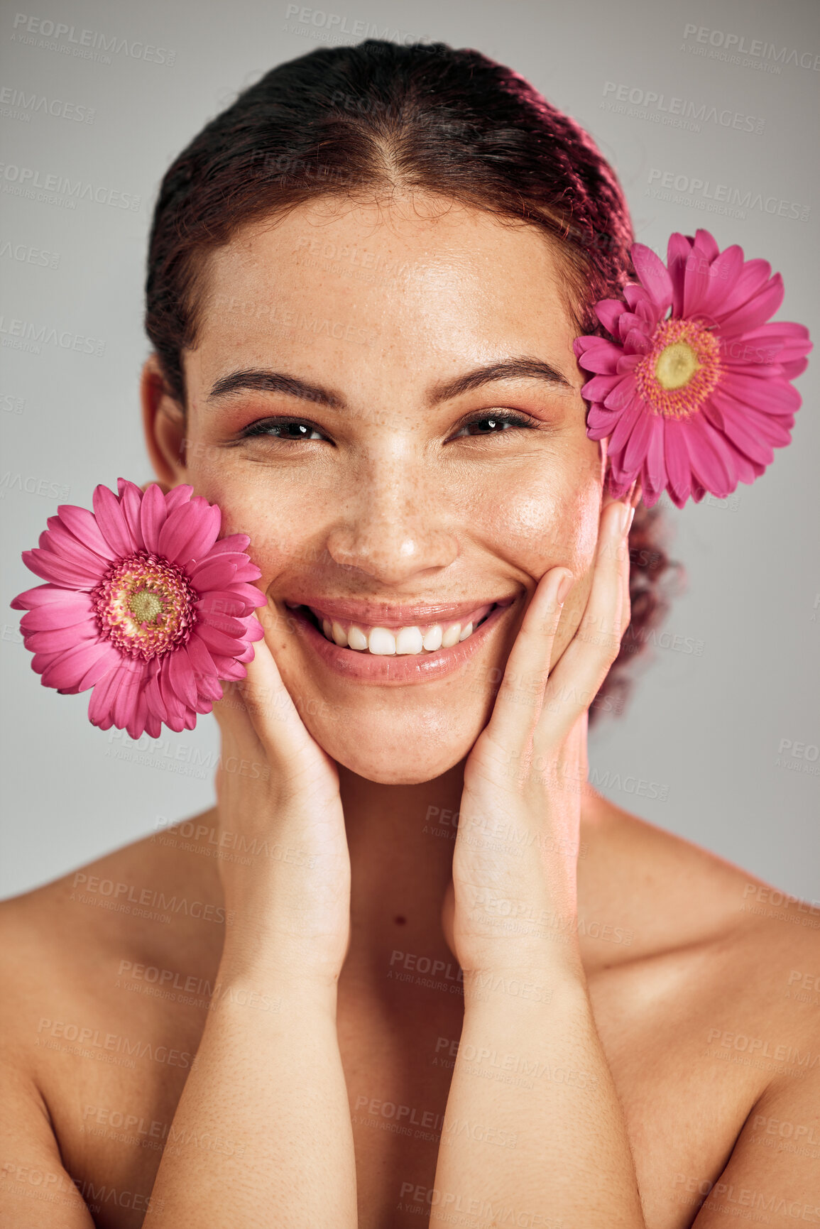 Buy stock photo Flowers, skincare and face portrait of a woman with natural beauty and a smile for dermatology. Facial, wellness and self care for skin glow, nature cosmetics or makeup of a healthy model in studio