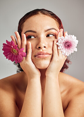 Buy stock photo Woman, studio and face with flowers for thinking, beauty or healthy skincare for natural spring aesthetic by background. Model, girl and carnation plant for cosmetic health, skin glow or eco friendly