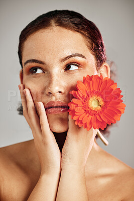 Buy stock photo Flower, skincare and glow of a woman with hands on face for dermatology, makeup and cosmetics. Facial, wellness and self care for natural skin, floral product and a healthy model thinking in studio