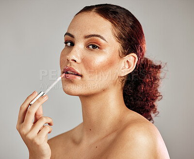 Buy stock photo Woman, makeup portrait and lip gloss application for beauty, cosmetics dermatology and skincare wellness in grey background. Female model, face and lipstick brush or lip balm product for self care