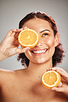 Orange, beauty and woman face in studio with a smile for natural skin glow, cosmetic and dermatology. Facial results, health and wellness of aesthetic model person happy with vitamin c fruit idea
